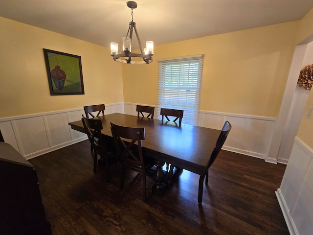 dining area featuring an inviting chandelier and dark wood-type flooring