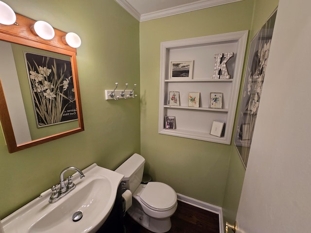 bathroom with ornamental molding, sink, and toilet