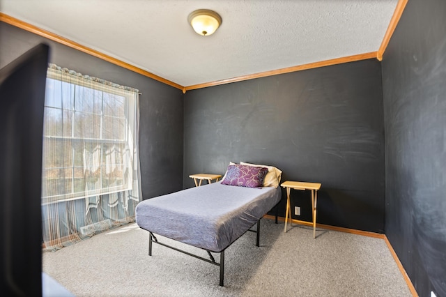 bedroom featuring crown molding, a textured ceiling, and carpet flooring