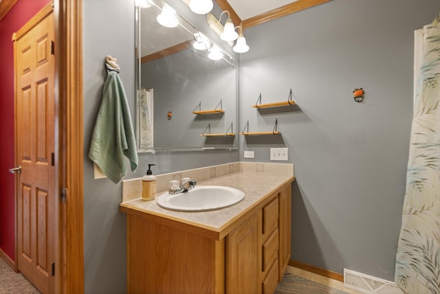 bathroom featuring vanity and ornamental molding