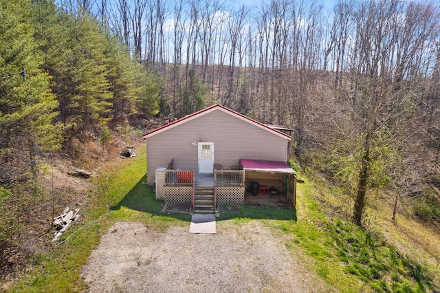 view of front of property with a wooden deck and a carport