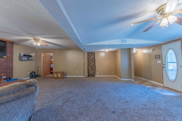 179 Bill Patrick Rd, Whitley City, KY 42653 - unfurnished living room with ceiling fan, a textured ceiling, carpet flooring, baseboards, and a fireplace