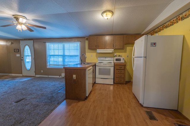 179 Bill Patrick Rd, Whitley City, KY 42653 - kitchen featuring white appliances, under cabinet range hood, a peninsula, brown cabinetry, and a sink