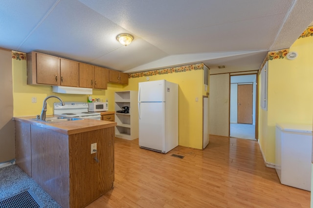 179 Bill Patrick Rd, Whitley City, KY 42653 - kitchen with white appliances, under cabinet range hood, light wood-style floors, vaulted ceiling, and a sink