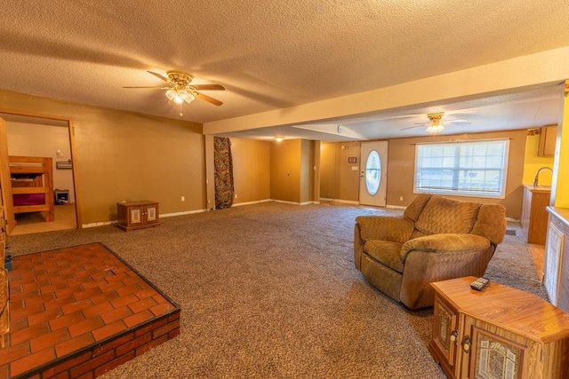 living room featuring ceiling fan, a textured ceiling, and carpet floors