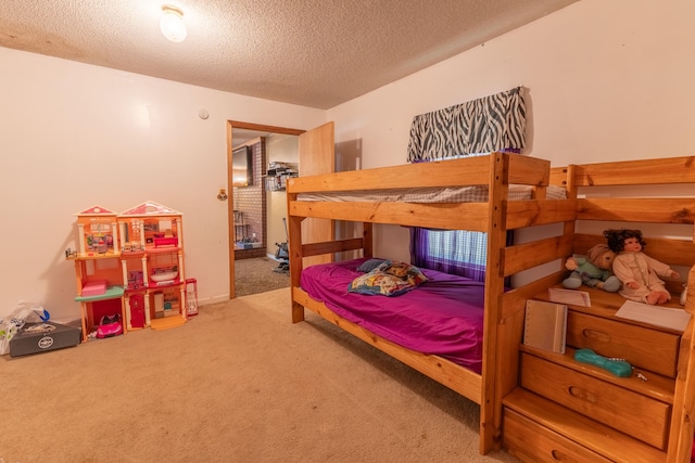 bedroom featuring carpet and a textured ceiling