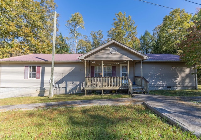 179 Bill Patrick Rd, Whitley City, KY 42653 - ranch-style house featuring covered porch, metal roof, a front lawn, and crawl space