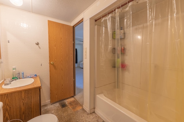 full bathroom with vanity, a textured ceiling, tile walls, toilet, and shower / tub combo with curtain