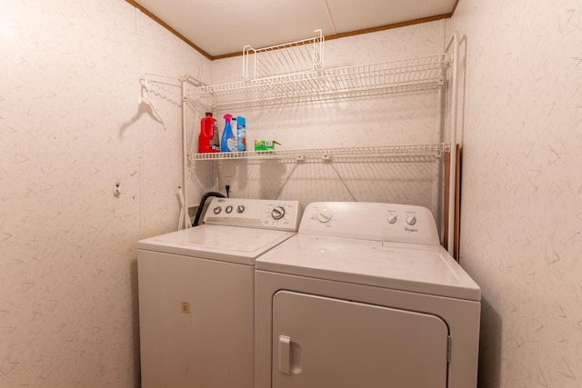 washroom with crown molding and washing machine and dryer