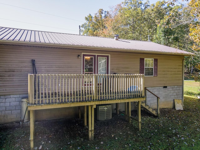 rear view of property featuring central AC unit and a wooden deck