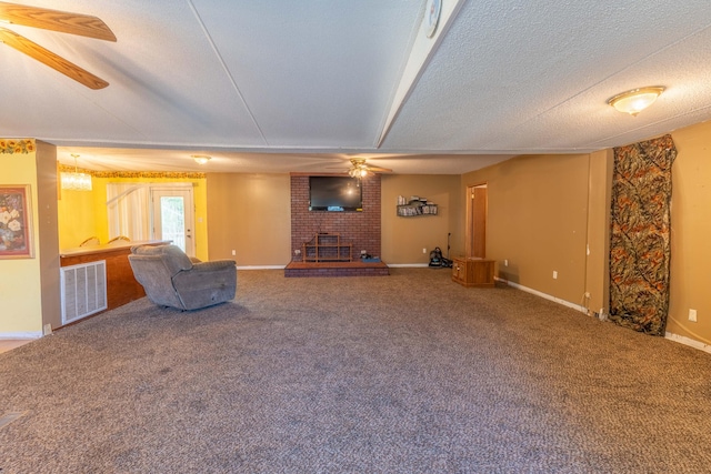 unfurnished living room with ceiling fan, carpet floors, and a textured ceiling