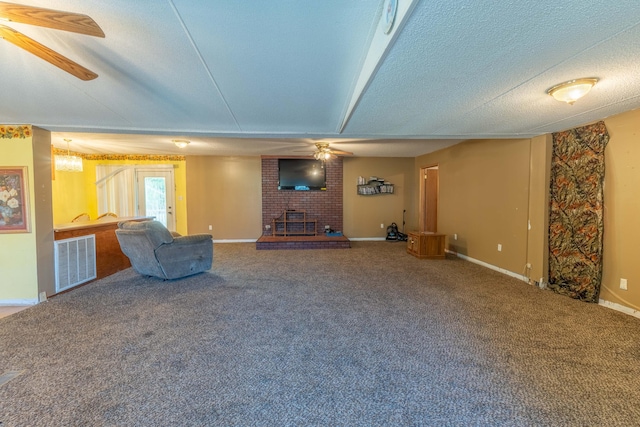 179 Bill Patrick Rd, Whitley City, KY 42653 - unfurnished living room featuring ceiling fan, carpet floors, baseboards, a fireplace, and a textured ceiling