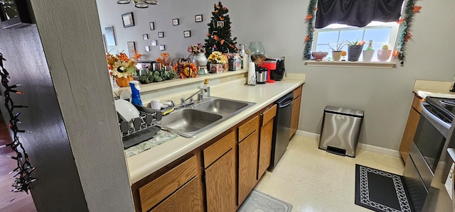 kitchen with black dishwasher, stainless steel electric range, and sink