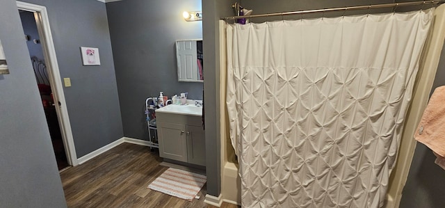 bathroom with vanity, shower / bathtub combination with curtain, and hardwood / wood-style floors