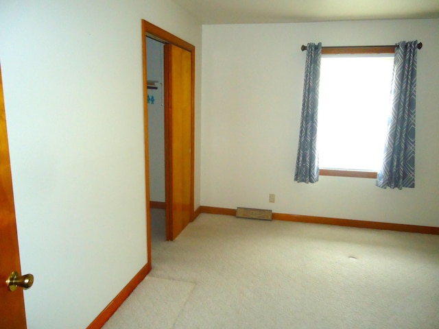 carpeted spare room with a healthy amount of sunlight