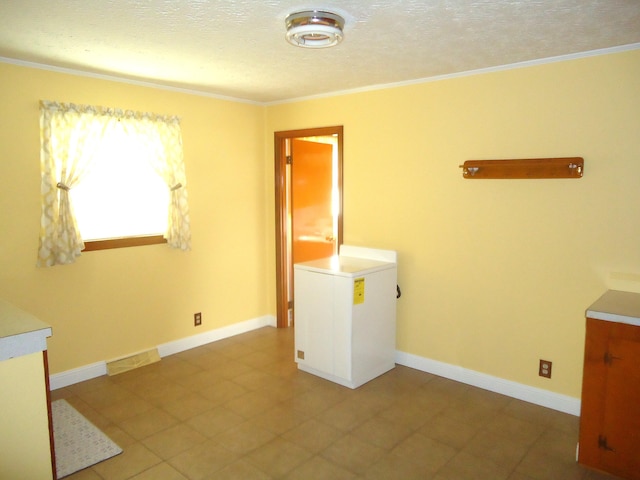 washroom featuring a textured ceiling and ornamental molding