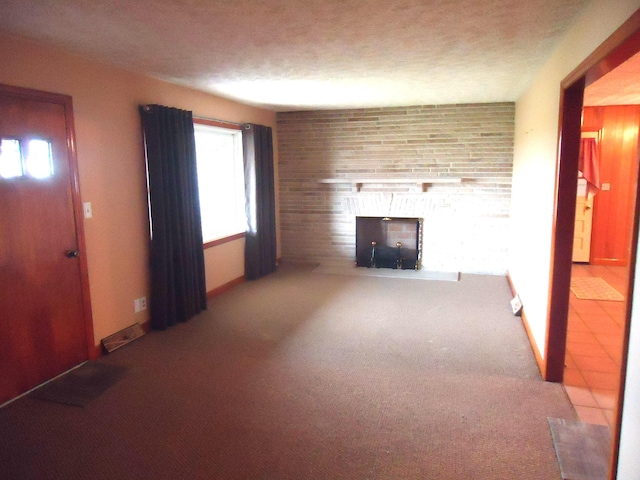 unfurnished living room featuring carpet, a textured ceiling, and a brick fireplace