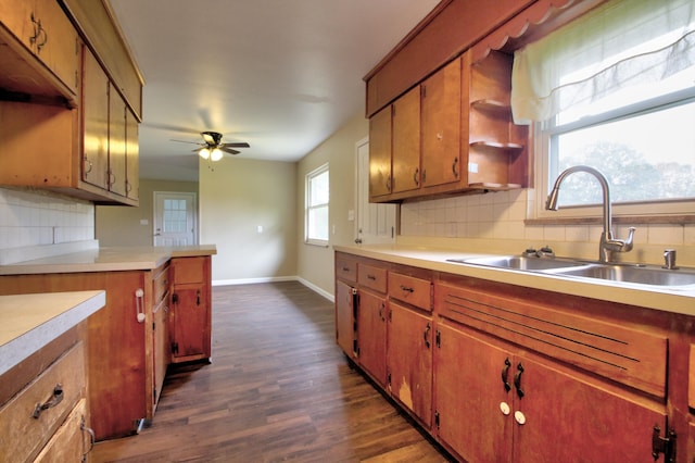 kitchen featuring dark hardwood / wood-style flooring, decorative backsplash, sink, and a healthy amount of sunlight