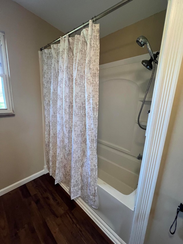 bathroom featuring hardwood / wood-style floors and shower / bath combination with curtain