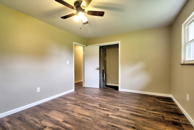 empty room featuring ceiling fan and dark hardwood / wood-style floors