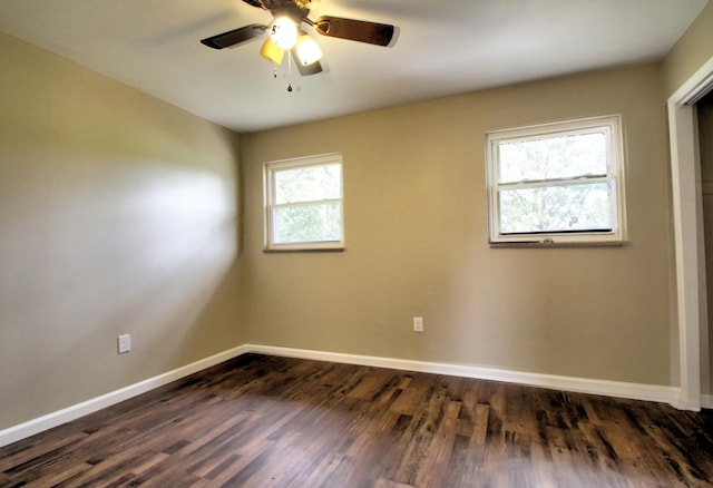 empty room featuring dark wood-type flooring and ceiling fan