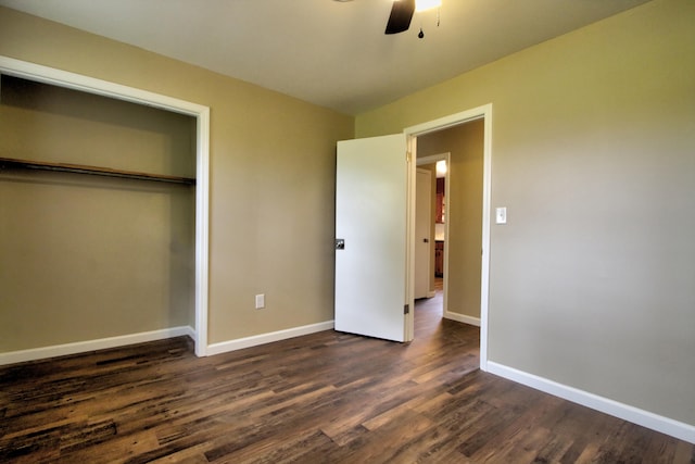 unfurnished bedroom featuring dark hardwood / wood-style flooring, ceiling fan, and a closet