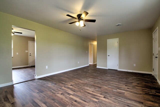 empty room featuring ceiling fan and dark hardwood / wood-style floors