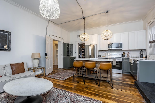 302 W High St, Lexington, KY 40507 - kitchen with appliances with stainless steel finishes, a chandelier, gray cabinetry, light countertops, and a kitchen island