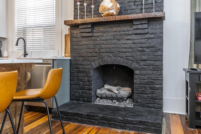 302 W High St, Lexington, KY 40507 - interior space featuring wood finished floors and a brick fireplace
