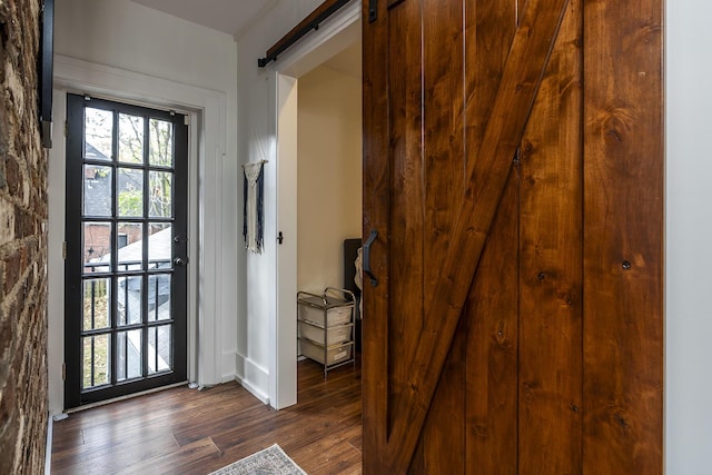 302 W High St, Lexington, KY 40507 - doorway to outside with a barn door, dark wood-type flooring, and baseboards