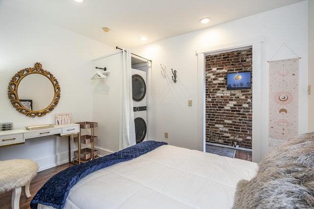 302 W High St, Lexington, KY 40507 - bedroom featuring stacked washer / drying machine and wood finished floors