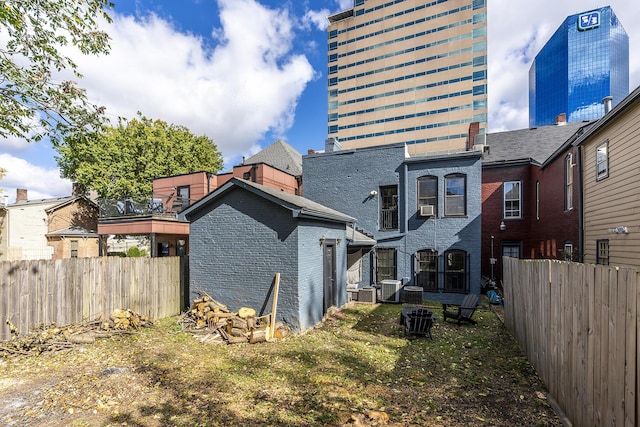 302 W High St, Lexington, KY 40507 - back of property with brick siding, central AC unit, and cooling unit