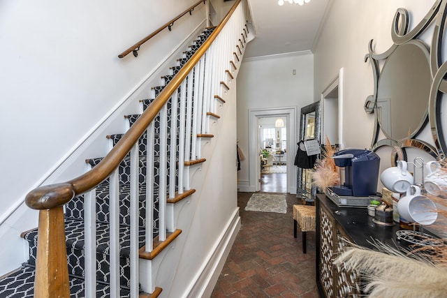 302 W High St, Lexington, KY 40507 - stairway featuring brick floors, ornamental molding, and baseboards