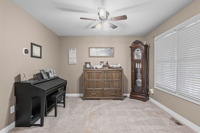 miscellaneous room with light carpet, a textured ceiling, and ceiling fan