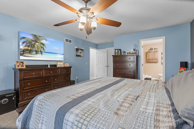 bedroom featuring ensuite bathroom, carpet flooring, a textured ceiling, and ceiling fan