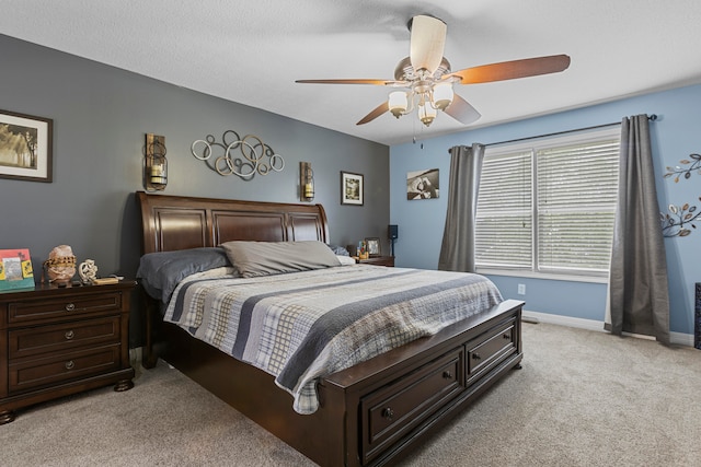 carpeted bedroom featuring ceiling fan and a textured ceiling