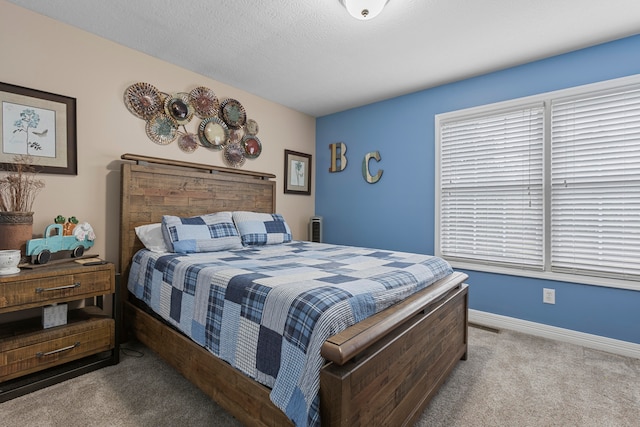 carpeted bedroom featuring a textured ceiling