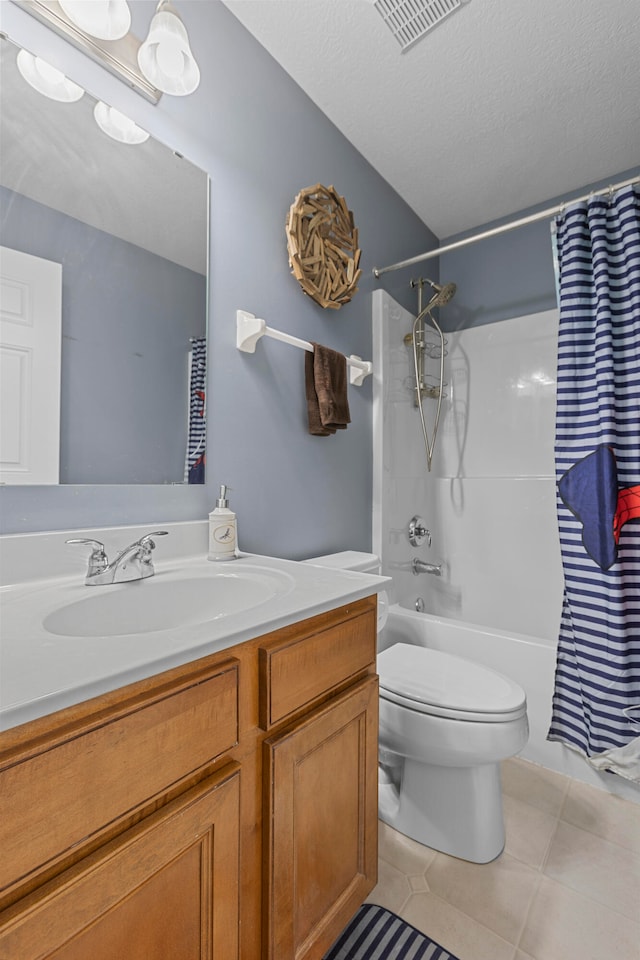 full bathroom with a textured ceiling, toilet, vanity, shower / tub combo with curtain, and tile patterned floors