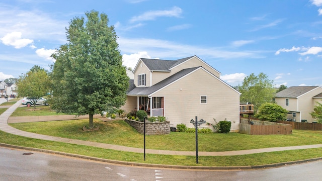 view of side of home featuring a yard and a porch