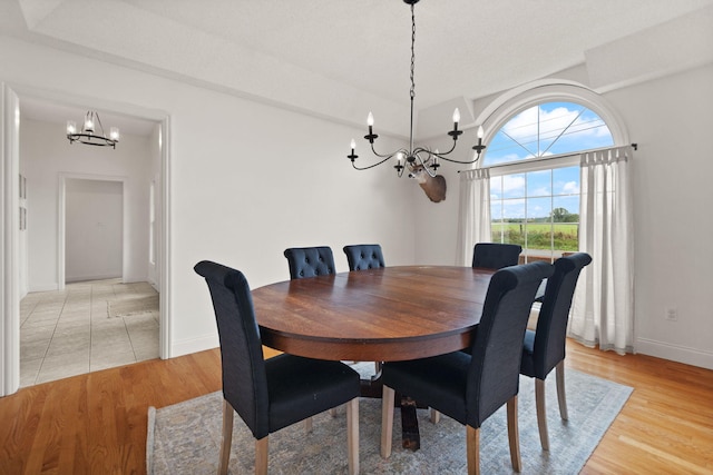 dining space with a chandelier and light wood-type flooring