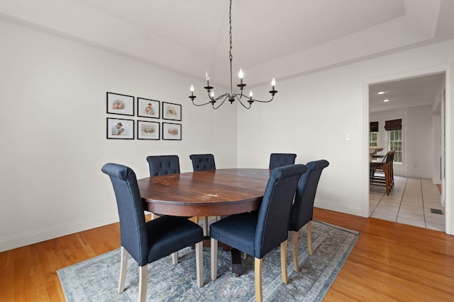 dining space with a notable chandelier and hardwood / wood-style flooring