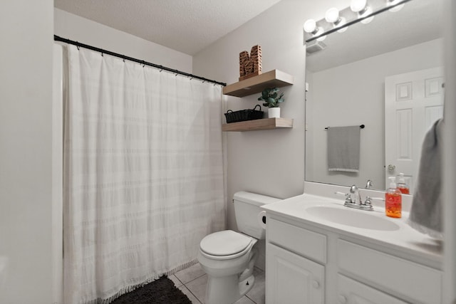 bathroom with toilet, tile patterned flooring, a shower with curtain, vanity, and a textured ceiling