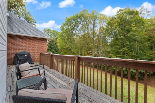 wooden terrace featuring area for grilling and a lawn