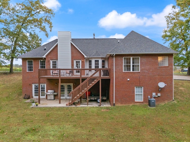 rear view of house featuring a yard, a patio area, a wooden deck, and central AC unit