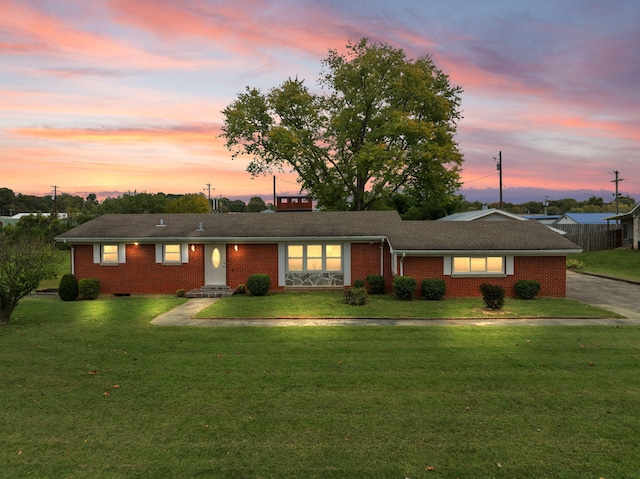 single story home featuring a yard