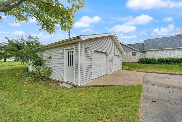 garage featuring a lawn