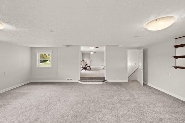 carpeted spare room with a textured ceiling