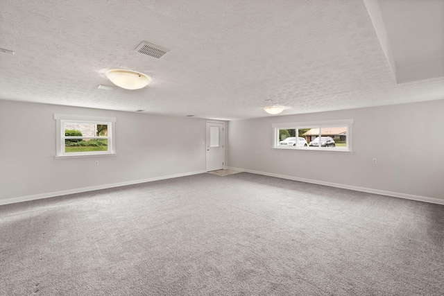 basement featuring a textured ceiling and carpet floors