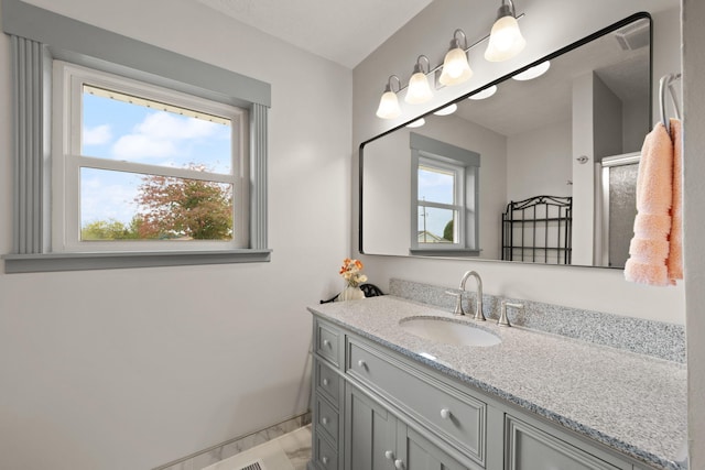 bathroom featuring vanity and an enclosed shower