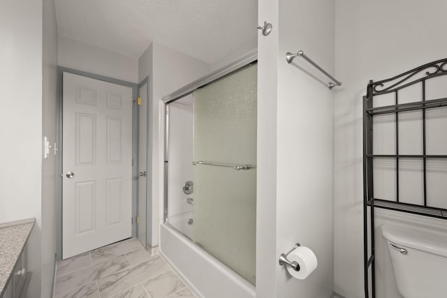 full bathroom featuring vanity, toilet, and shower / bath combination with glass door